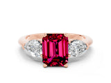 Rose gold Three-Stone Emerald Cut Garnet Ring with Pear Side Stones and Four-Prong Setting