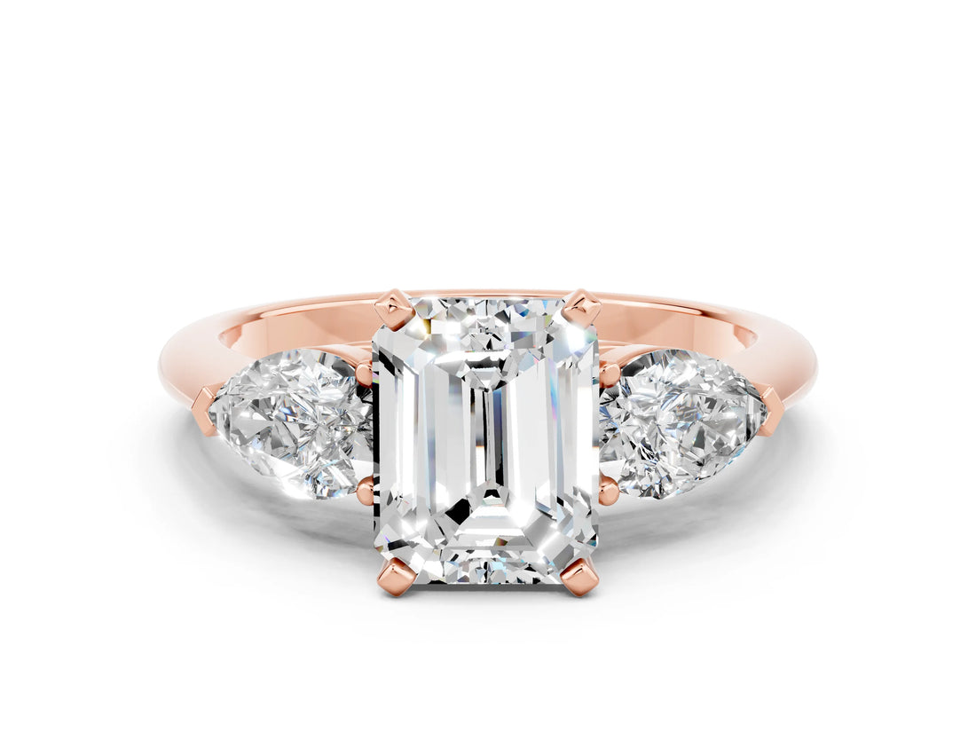 Rose gold Three-Stone Emerald Cut Moissanite Ring with Pear Side Stones and Four-Prong Setting