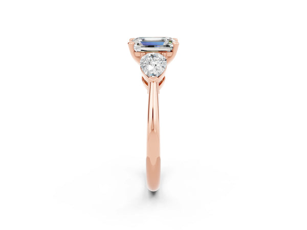 Rose gold Three-Stone Emerald Cut Moissanite Ring with Pear Side Stones and Four-Prong Setting