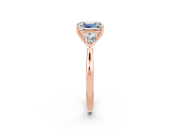 Rose gold Three-Stone Emerald Cut Moissanite Ring with Pear  Side Stones in Four-Prong Setting