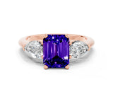 Rose gold Three-Stone Emerald Cut Tanzanite Ring with Pear Side Stones and Four-Prong Setting