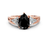Rose gold Three-Stone Fancy Black Pear Cut Cut Diamond Ring with Trillion Side Stones on a Split Shank Band