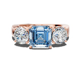 Rose gold Three-Stone Fancy Blue Asscher Cut Diamond Ring with Round Side Stones, Classic Band, and Four-Prong Setting