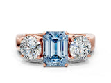 Rose gold Three-Stone Fancy Blue Emerald Cut Diamond Ring with Round Side Stones, Classic Band, and Four-Prong Setting