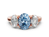 Rose gold Three-Stone Fancy Blue Oval Cut Cut Diamond Ring with Channel Set Band and Four-Prong Setting