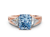 Rose gold Three-Stone Fancy Blue Radiant Cut Cut Diamond Ring with Trillion Side Stones on a Split Shank Band