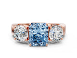 Rose gold Three-Stone Fancy Blue Radiant Cut Diamond Ring with Round Side Stones, Classic Band, and Four-Prong Setting