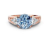 Rose gold Three-Stone Fancy Blue Round Cut Cut Diamond Ring with Trillion Side Stones on a Split Shank Band