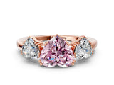 Rose gold Three-Stone Fancy Pink Heart Cut Cut Diamond Ring with Channel Set Band and Four-Prong Setting
