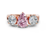 Rose gold Three-Stone Fancy Pink Pear Cut Diamond Ring with Round Side Stones, Classic Band, and Four-Prong Setting