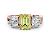 Rose gold Three-Stone Fancy Yellow Emerald Cut Diamond Ring with Round Side Stones, Classic Band, and Four-Prong Setting