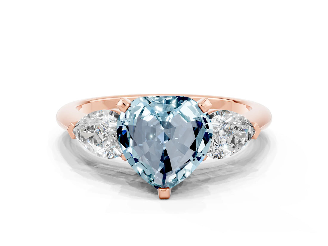 Rose gold Three-Stone Heart Cut Aquamarine Ring with Pear Side Stones and Four-Prong Setting