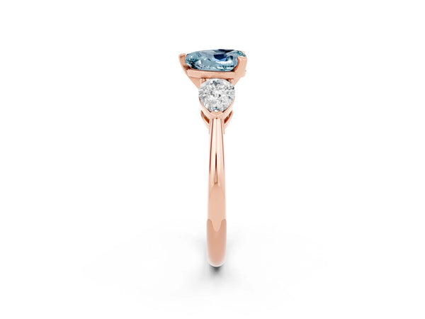 Rose gold Three-Stone Heart Cut Aquamarine Ring with Pear Side Stones and Four-Prong Setting