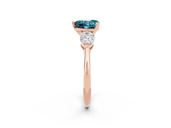 Rose gold Three-Stone Heart Cut Blue Topaz Ring with Pear Side Stones and Four-Prong Setting