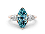Rose gold Three-Stone Marquise Cut Blue Topaz Ring with Pear Side Stones and Four-Prong Setting