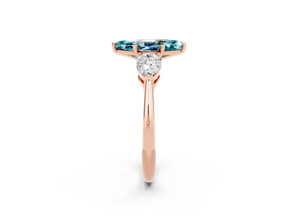 Rose gold Three-Stone Marquise Cut Blue Topaz Ring with Pear Side Stones and Four-Prong Setting