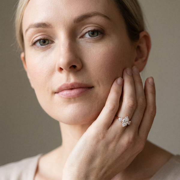 Rose gold Three-Stone Marquise Cut Diamond Ring with Round Accent Stones, Prong Setting, and Classic Band