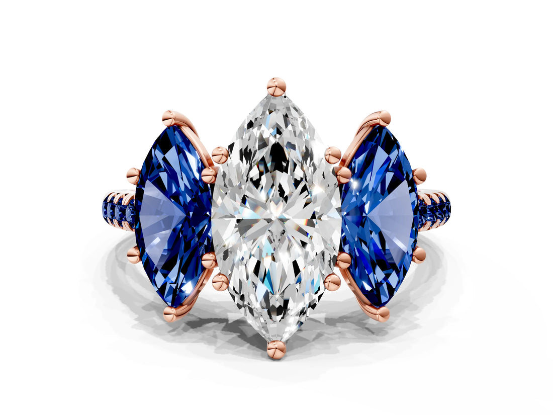 Rose gold Three-Stone Marquise Cut Diamond Ring with Round with Blue Sapphire side stone Pavé Band and Prong Setting