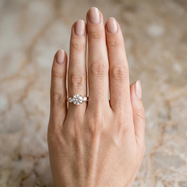 Rose gold Three-Stone Marquise Diamond Solitaire with Round Accents and Prong Setting on a Classic Band