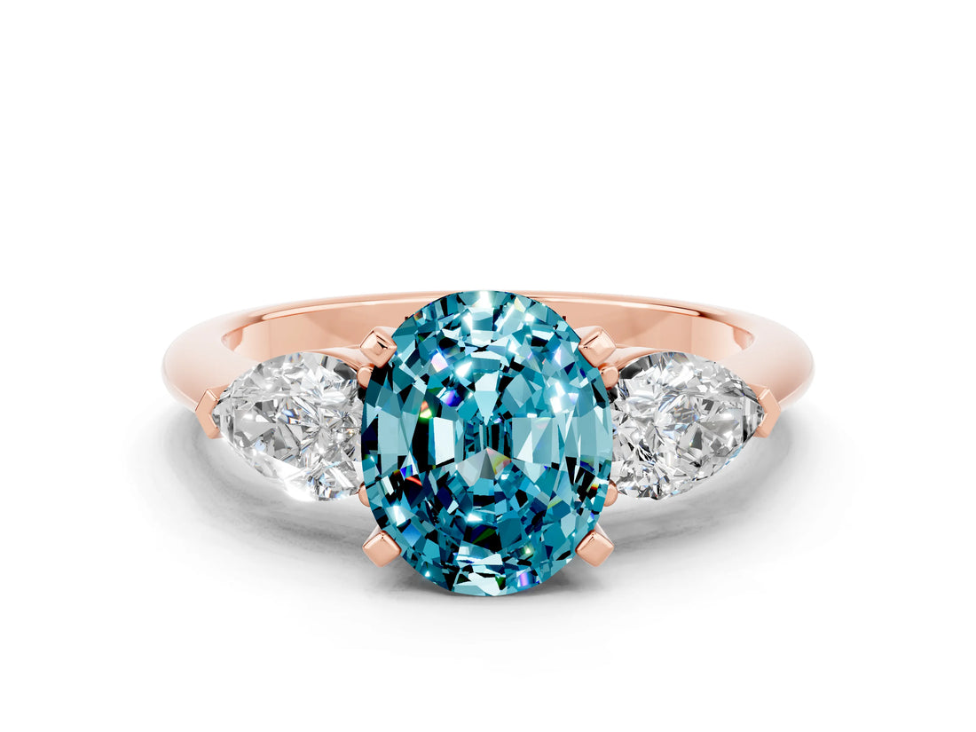 Rose gold Three-Stone Oval Cut Blue Topaz Ring with Pear Side Stones and Four-Prong Setting