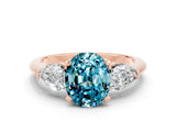 Rose gold Three-Stone Oval Cut Blue Topaz Ring with Pear Side Stones and Four-Prong Setting