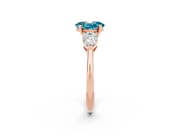 Rose gold Three-Stone Oval Cut Blue Topaz Ring with Pear Side Stones and Four-Prong Setting