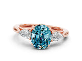 Rose gold Three-Stone Oval Cut Blue Topaz Ring with Pear  Side Stones in Four-Prong Setting_12