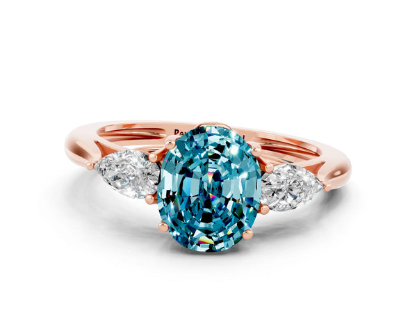 Rose gold Three-Stone Oval Cut Blue Topaz Ring with Pear  Side Stones in Four-Prong Setting
