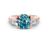 Rose gold Three-Stone Oval Cut Cut Diamond Ring with Trillion Side Stones and Four-Prong Setting