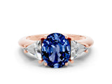 Rose gold Three-Stone Oval Cut Cut Diamond Ring with Trillion Side Stones and Four-Prong Setting