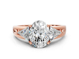 Rose gold Three-Stone Oval Cut Cut Diamond Ring with Trillion Side Stones on a Split Shank Band_13