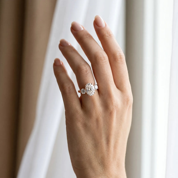 Rose gold Three-Stone Oval Cut Diamond Engagement Ring with Prong Setting on a White Gold Band