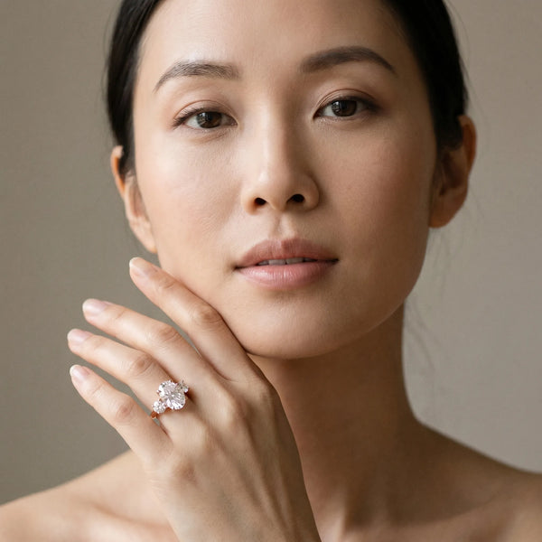 Rose gold Three-Stone Oval Cut Diamond Engagement Ring with Prong Setting on a White Gold Band