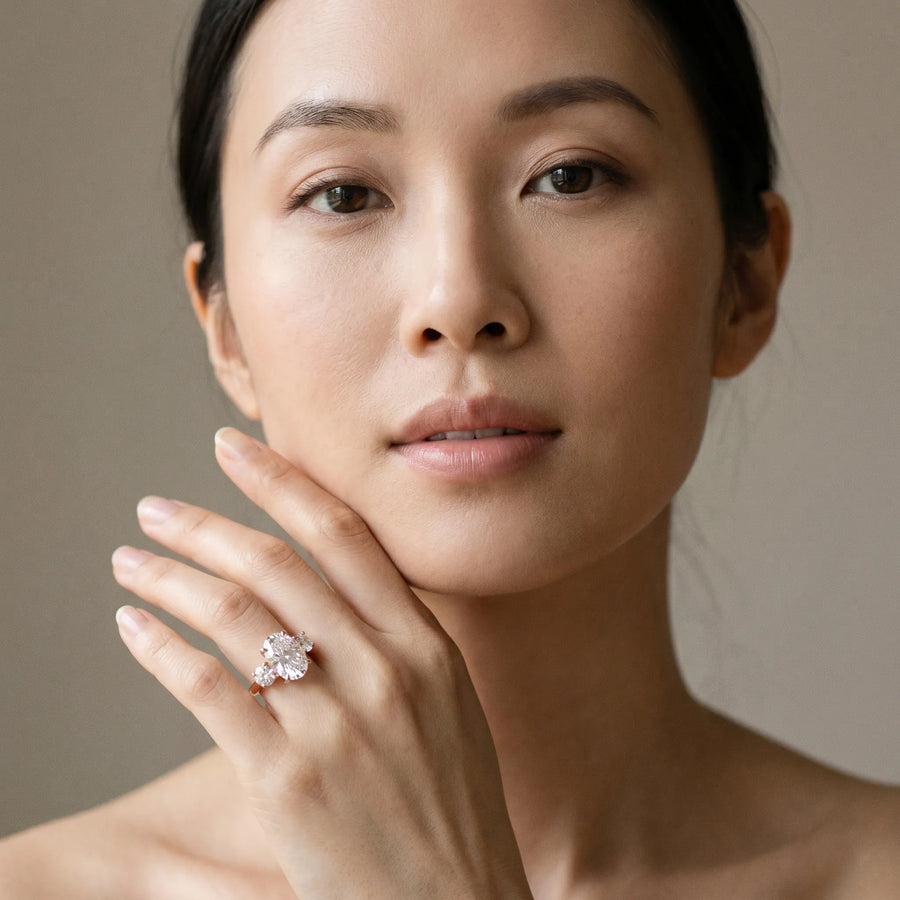 Rose gold Three-Stone Oval Cut Diamond Engagement Ring with Prong Setting on a White Gold Band