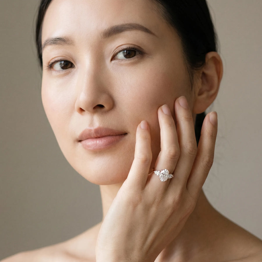 Rose gold Three-Stone Oval Cut Diamond Ring with Pear Side Stones and Four-Prong Setting