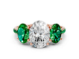 Rose gold Three-Stone Oval Cut Diamond Ring with Round with Emerald side stone Pavé Band and Prong Setting