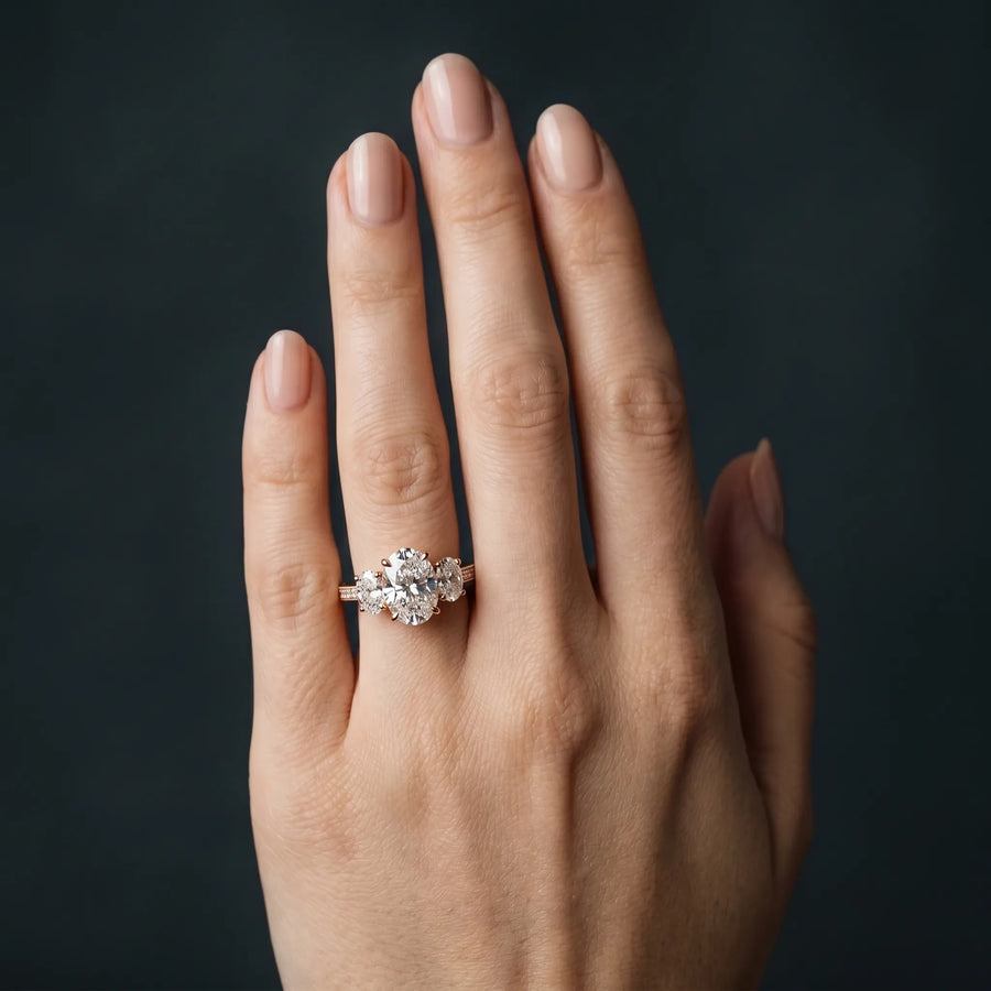 Rose gold Three-Stone Oval Diamond Engagement Ring with Prong Setting on a Classic Band