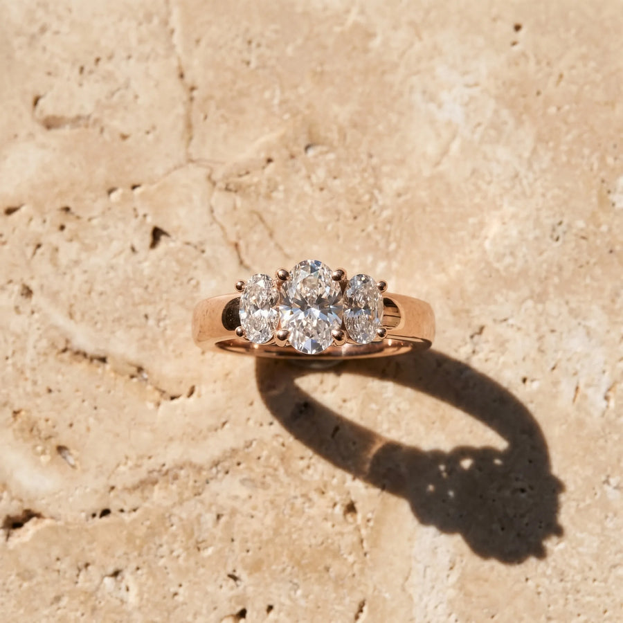 Rose gold Three-Stone Oval Diamond Ring with Channel Band and Prong Setting