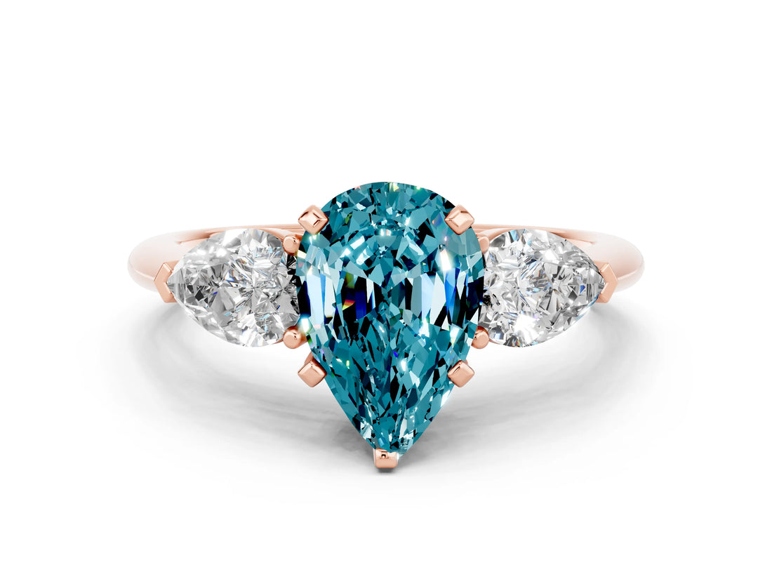Rose gold Three-Stone Pear Cut Blue Topaz Ring with Pear Side Stones and Four-Prong Setting