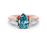 Rose gold Three-Stone Pear Cut Cut Diamond Ring with Trillion Side Stones and Four-Prong Setting