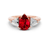 Rose gold Three-Stone Pear Cut Cut Diamond Ring with Trillion Side Stones and Four-Prong Setting