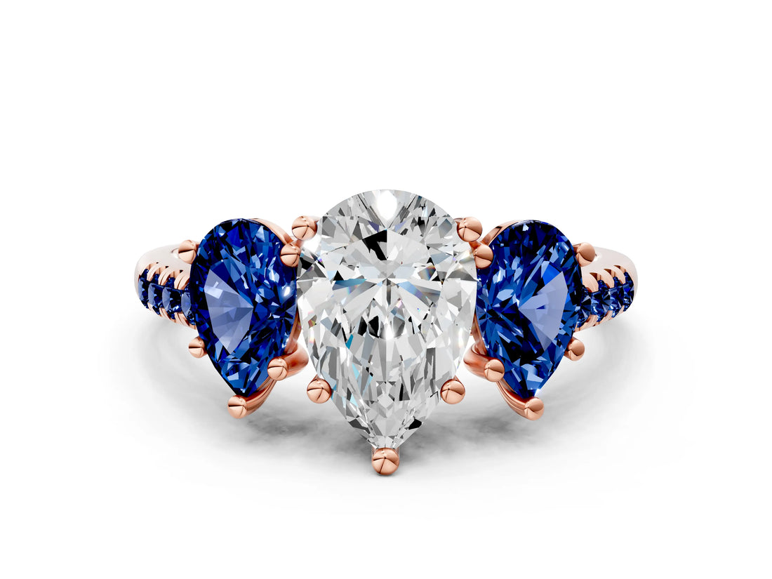 Rose gold Three-Stone Pear Cut Diamond Ring with Round with Blue Sapphire side stone Pavé Band and Prong Setting
