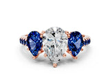 Rose gold Three-Stone Pear Cut Diamond Ring with Round with Blue Sapphire side stone Pavé Band and Prong Setting