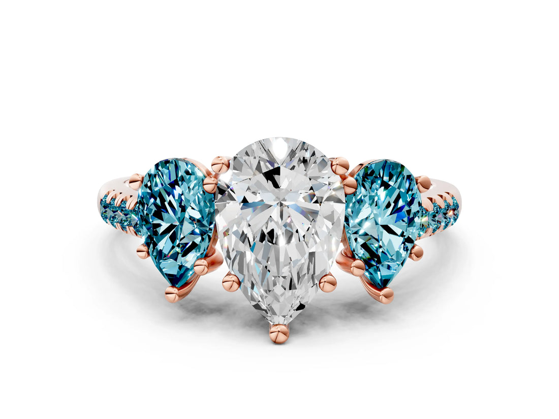 Rose gold Three-Stone Pear Cut Diamond Ring with Round with Blue Topaz side stone Pavé Band and Prong Setting