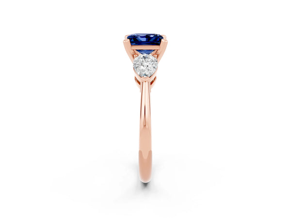 Rose gold Three-Stone Princess Cut Blue Sapphire Ring with Pear Side Stones and Four-Prong Setting