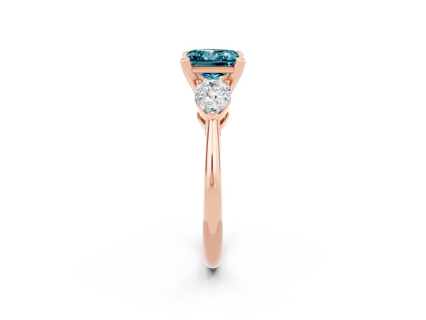 Rose gold Three-Stone Princess Cut Blue Topaz Ring with Pear Side Stones and Four-Prong Setting