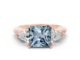 Rose gold Three-Stone Princess Cut Cut Diamond Ring with Trillion Side Stones and Four-Prong Setting