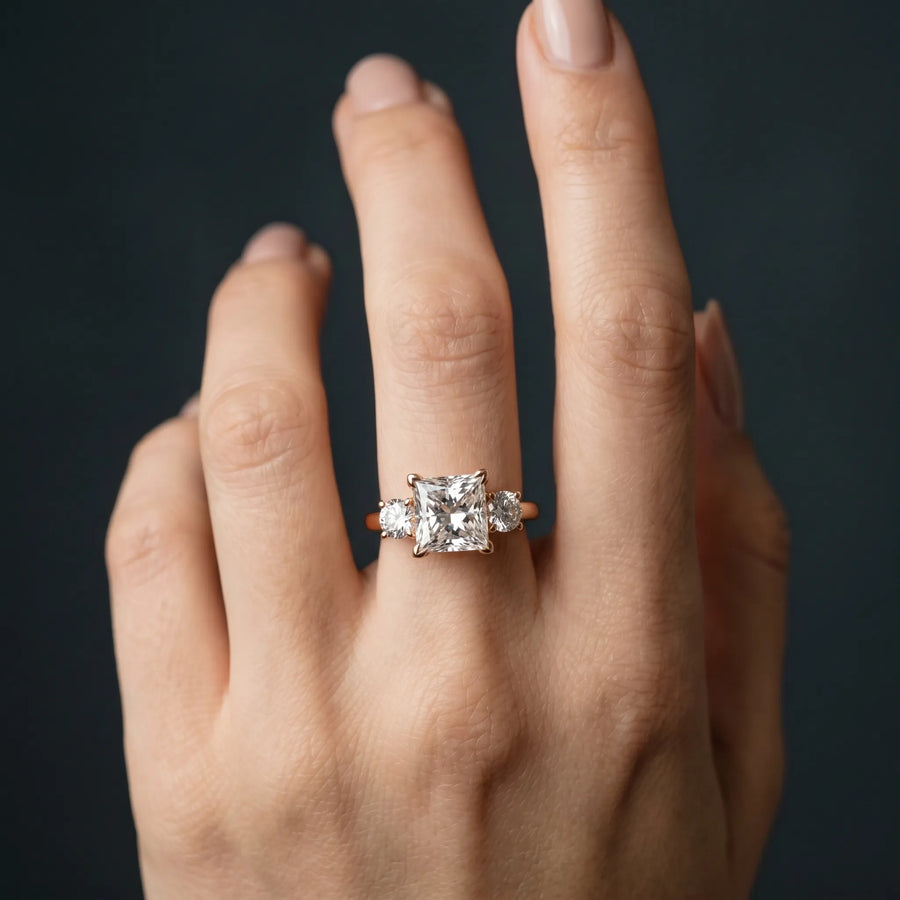 Rose gold Three-Stone Princess Cut Diamond Engagement Ring with Prong Setting on a White Gold Band