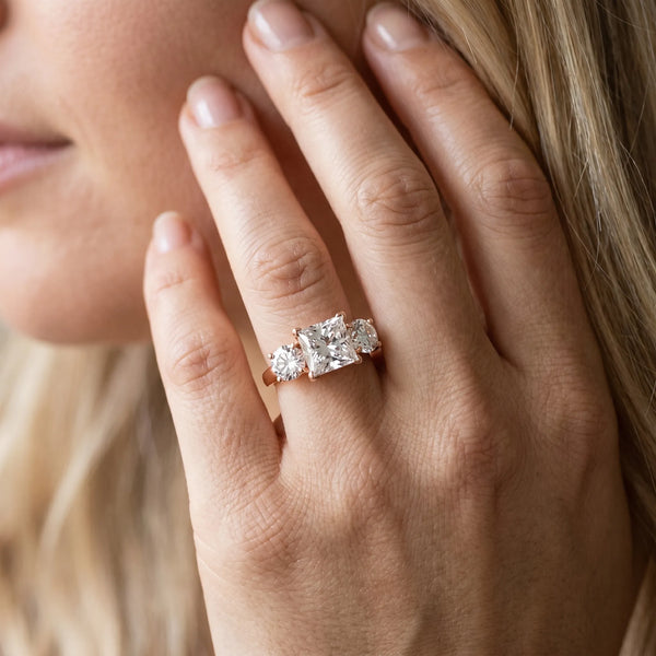 Rose gold Three-Stone Princess Cut Diamond Engagement Ring with Prong Setting on a White Gold Band