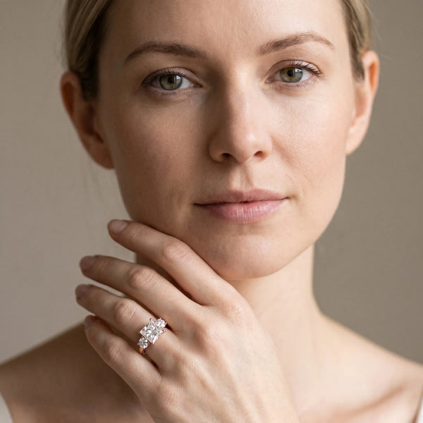 Rose gold Three-Stone Princess Cut Diamond Ring with Round Accent Stones, Prong Setting, and Classic Band